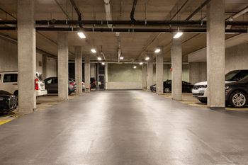 an empty parking garage with cars parked in it